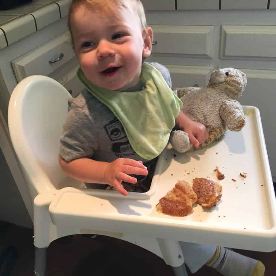 Ollie laughing in high chair